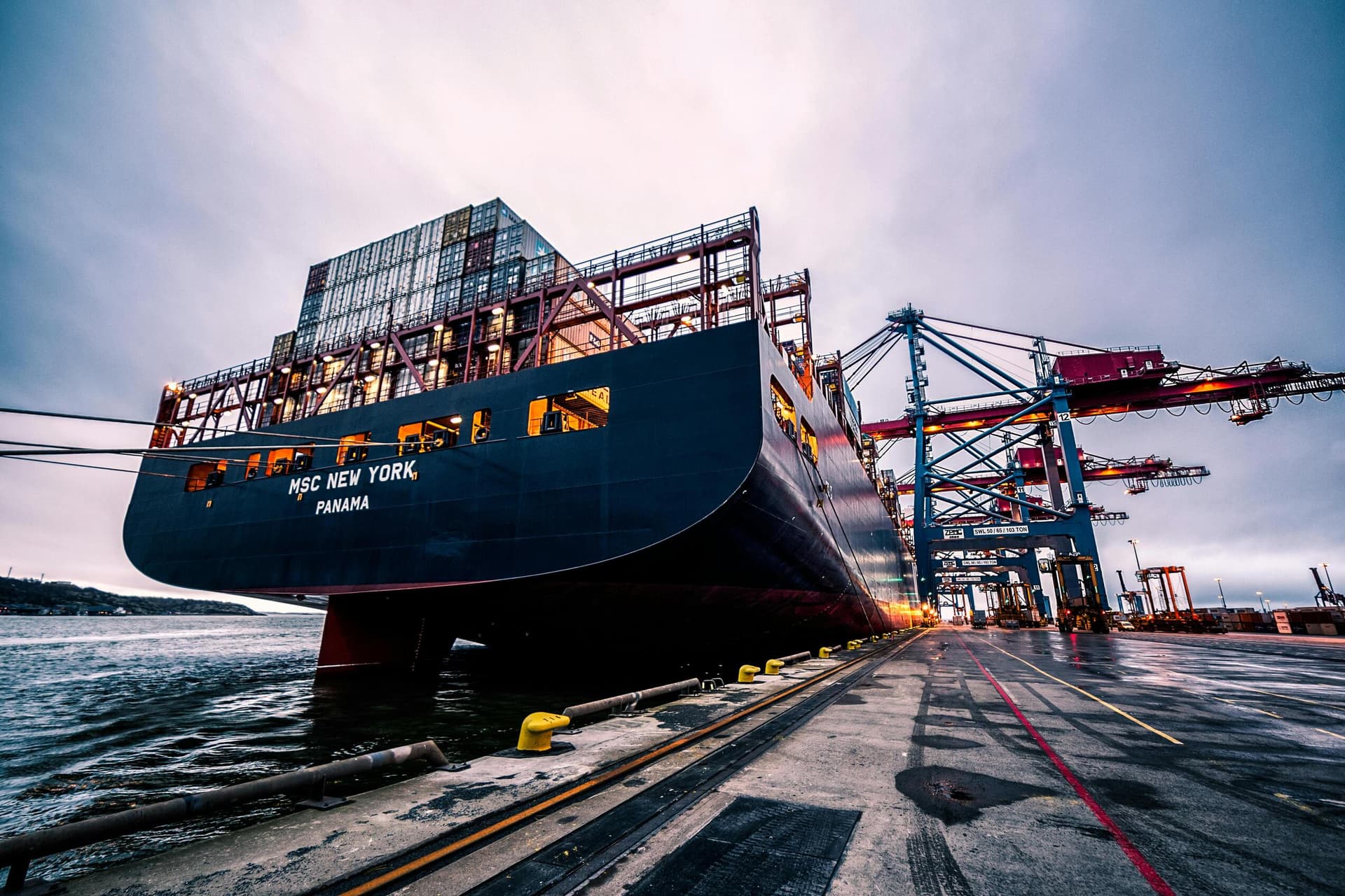 Container Ship at Port with Loading Cranes